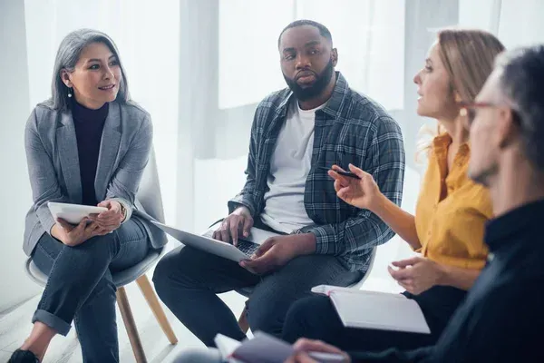 A team sitting in a circle discussing results